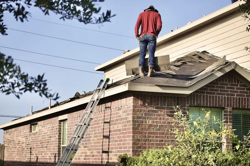 Professional roofer working on a residential roof in Fostertown